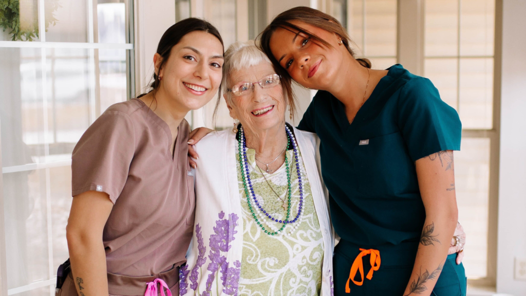 A resident with the employees Traditions at Serenity Villa