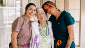 A resident with the employees Traditions at Serenity Villa