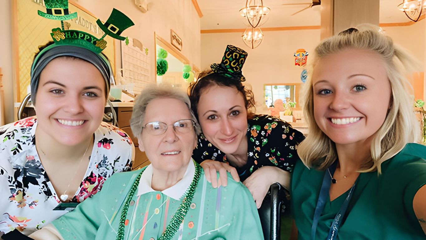 Resident and employees enjoying a joyful interaction at Traditions at Serenity Villa