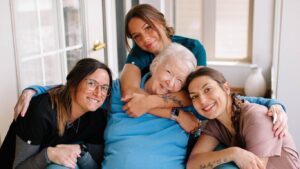 A caregiver and resident joyfully embracing each other at Serenity Villa