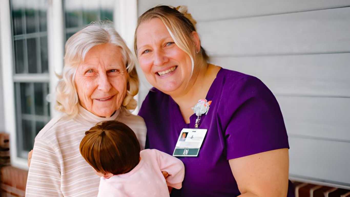 A resident shares a cheerful moment with a caregiver at Lily Meadows