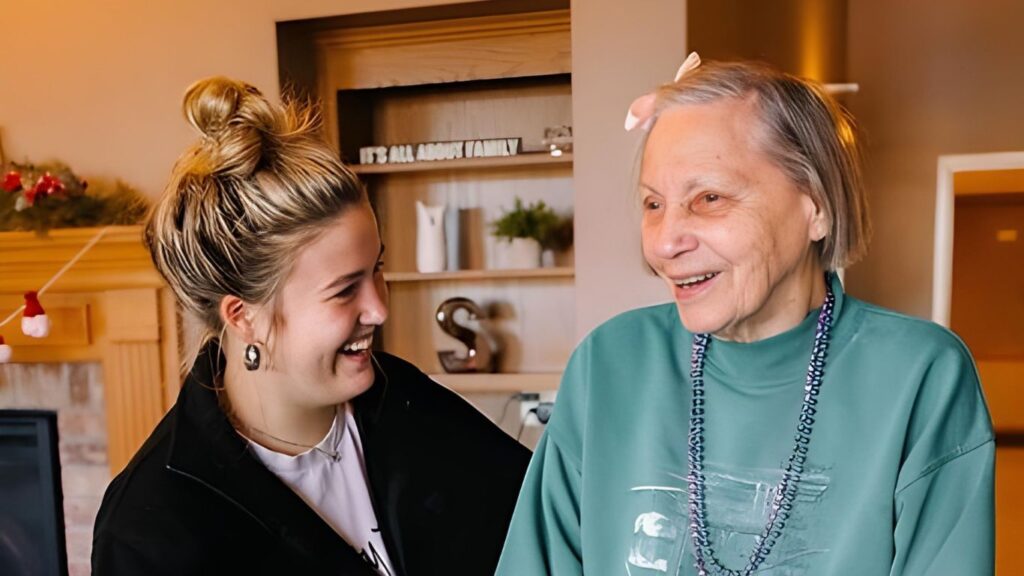 A resident and staff member sharing a joyful smile at Serenity Villa