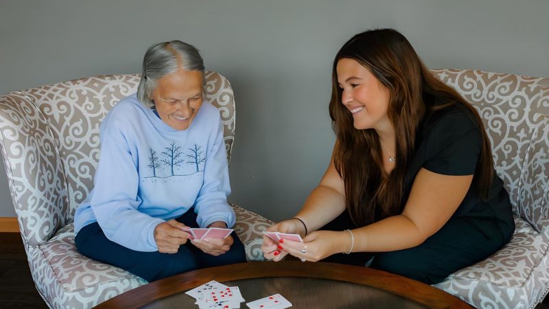 Resident enjoying playful interaction with caregiver at Serenity Villa