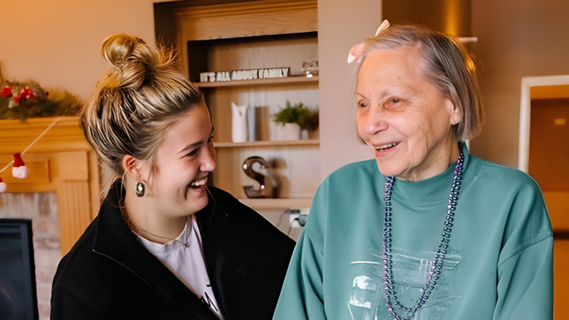 Shared warm moment of a resident with an employee at Traditions at Serenity Villa